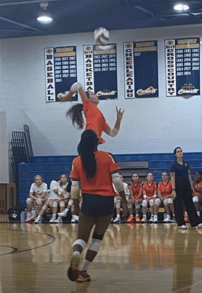 Coach Everett looks on as her team spikes the ball. (Alamar Alyamani/CC)

